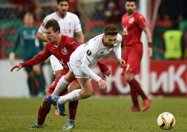 Maksim Kanunnikov (left) is challenged by Liverpool's Joe Allen in Moscow. Picture: Getty Images