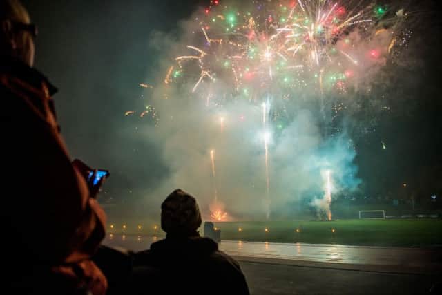 Spectators watch the fireworks display at Edinburgh's Meadowbank Stadium. Picture: Ian Georgeson