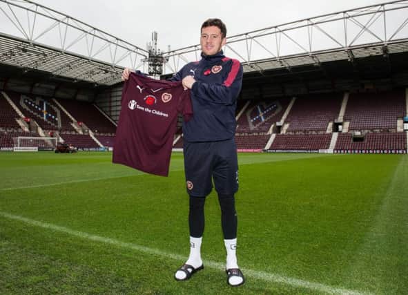 Danny Swanson shows off Hearts poppy appeal strip that will be worn today against Hamilton. Picture: SNS