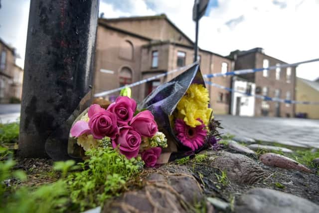 Flowers are seen left at Market Street in Montrose. Picture: HeMedia