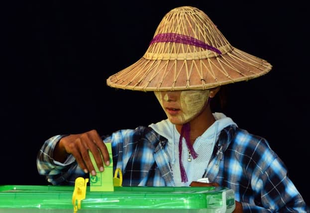 A woman casts her vote in a polling station in Naypyitaw, Myanmar, yesterday. Picture: AP