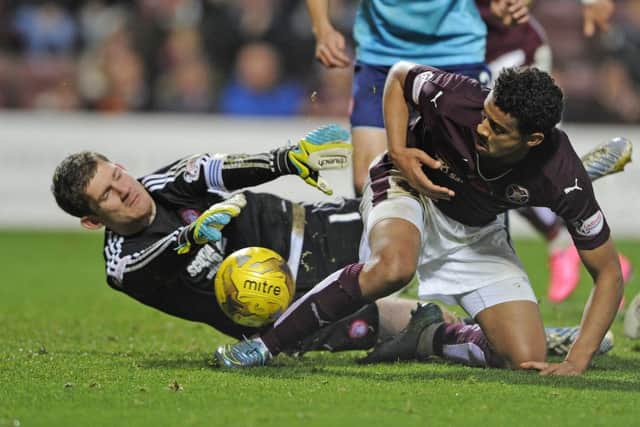 Hamilton goalkeeper Michael McGovern dives at the feet of Hearts striker Osman Sow during a rumbustious encounter. Picture: Neil Hanna
