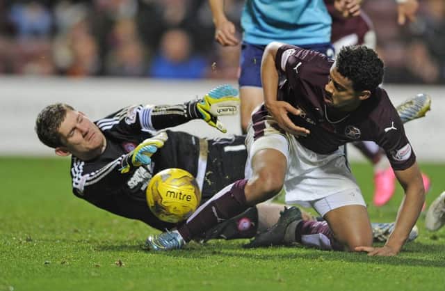 Hamilton goalkeeper Michael McGovern dives at the feet of Hearts striker Osman Sow during a rumbustious encounter. Picture: Neil Hanna