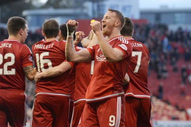 Adam Rooney celebrates after giving the Dons a 1-0 lead early in the second half, the strikers ninth goal of the season. Picture: SNS