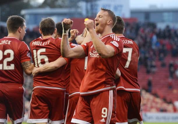 Adam Rooney celebrates after giving the Dons a 1-0 lead early in the second half, the strikers ninth goal of the season. Picture: SNS