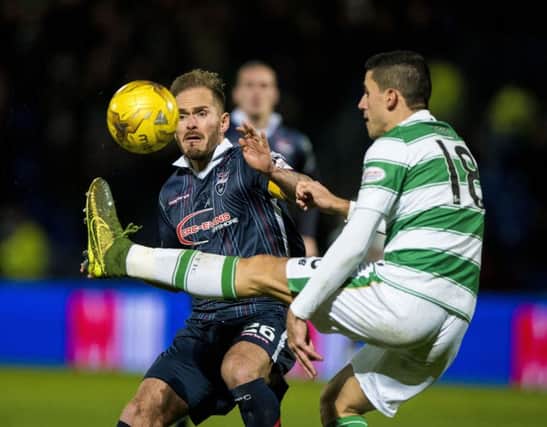Ross County's Martin Woods and Celtic's Tomas Rogic. Picture: PA