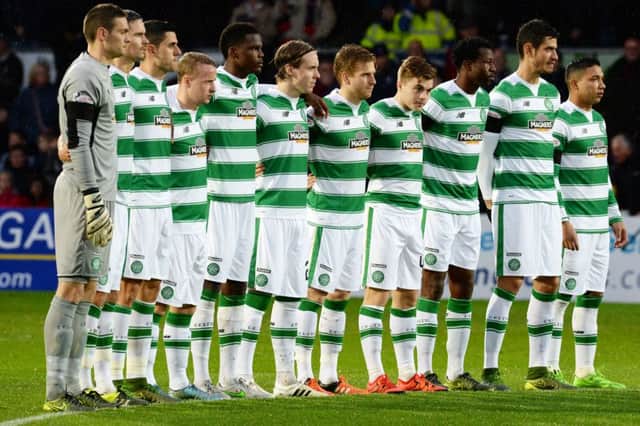 The Celtic players observe a minute's silence before the game at Ross County. Picture: SNS