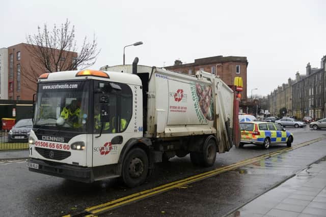 The bin lorry sits by the side of the road which was closed by police after the accident. Picture: Julie Bull