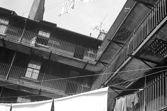 Washing day in Old Edinburgh - a clothes line is strung from balcony to balcony in Tron Square, October 1958