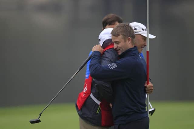 Russell Knox embraces his caddie after winning the HSBC Champions in Shanghai on Sunday. Picture: AP