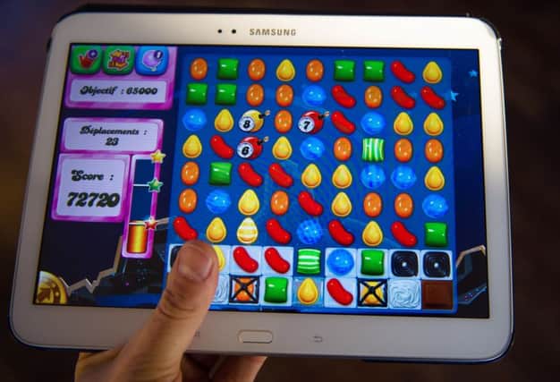 A person plays Candy Crash Saga on a tablet. Picture: AFP/Getty Images