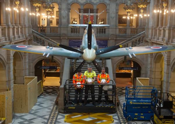 Spitfire LA198 is lowered to the ground for Amistice Day at Kelvingrove Art Gallery and Museum. Picture: John Devlin
