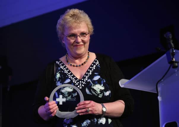 Community Staff Nurse Karen Duncan of OWLS Perth holds her Scottish Health Awards prize at the Corn Exchange in Edinburgh. Photo: Alasdair MacLeod.