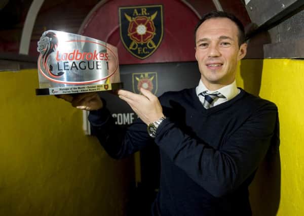 Albion Rovers player/manager Darren Young proudly shows off his October Manager of the Month trophy at Cliftonhill yesterday. Picture: SNS Group