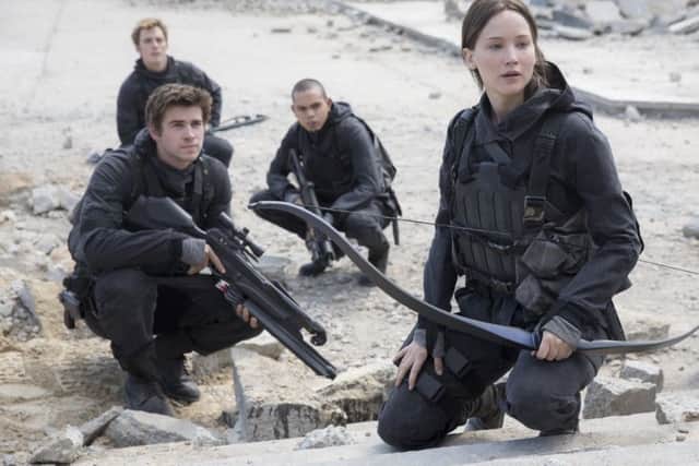 Jennifer Lawrence as Katniss Everdeen, Liam Hemsworth as Gale Hawthorne, Evan Ross as Messalla and Sam Claflin as Finnick Odair in The Hunger Games: Mockingjay Part 2