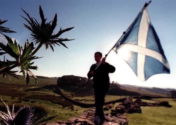 Saltire flag and silhouetted thistles in the borders.