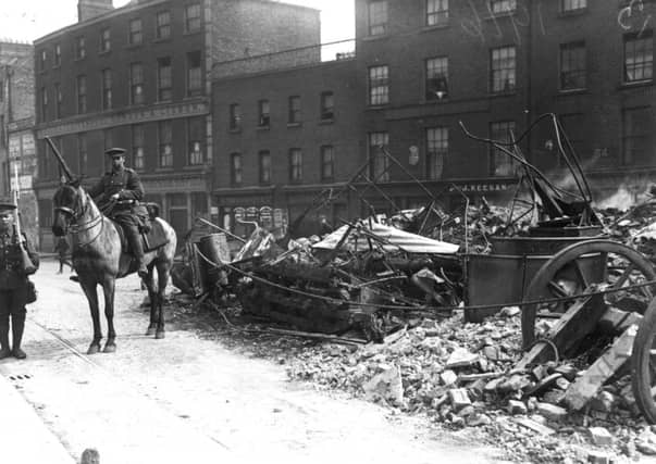 A Lancer on guard in Dublin beside a tramcar used as a barricade during the Easter Rising. Picture: Getty Images