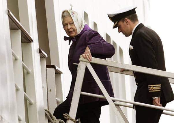 The Queen arrives with Captain Michael Hepburn to embark on the Hebridean Princess for a cruise to celebrate her 80th birthday in 2006. Picture: Andrew Milligan/PA