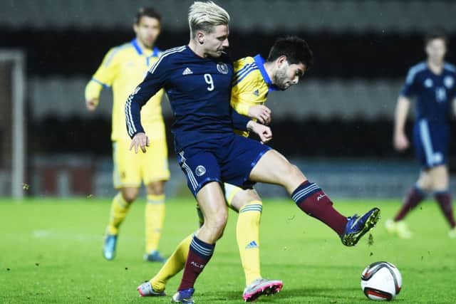 Scotland's Under-21 Jason Cummings (front) battles with Ukraine's U21 Ihor Zhurakhovskyi. Picture: SNS Group