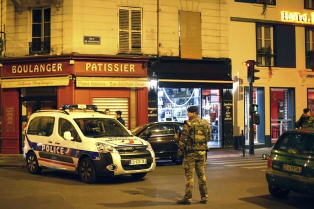 A French soldier stands in a street next to Rue de Charonne. A cafe nearby was one of the targeted sites. Picture: AP