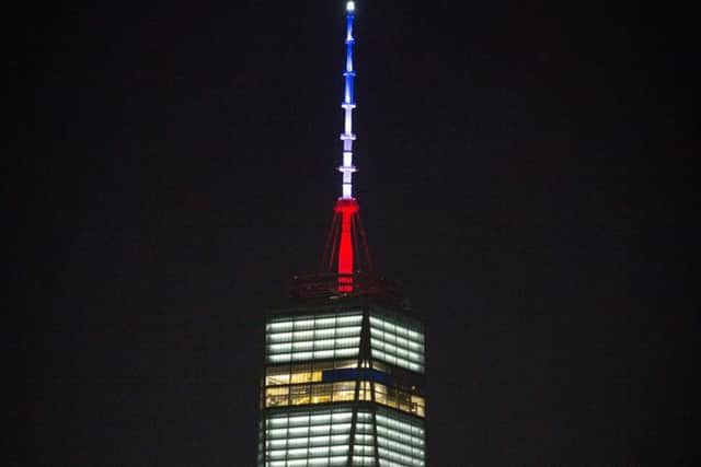 The One World Trade Center spire is lit blue, white and red in honor of dozens killed in the Paris attacks. Picture: AP