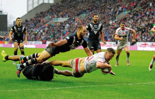 England's Elliott Whitehead scores a try during the International Test Series match at the DW Stadium, Wigan. Picture: PA