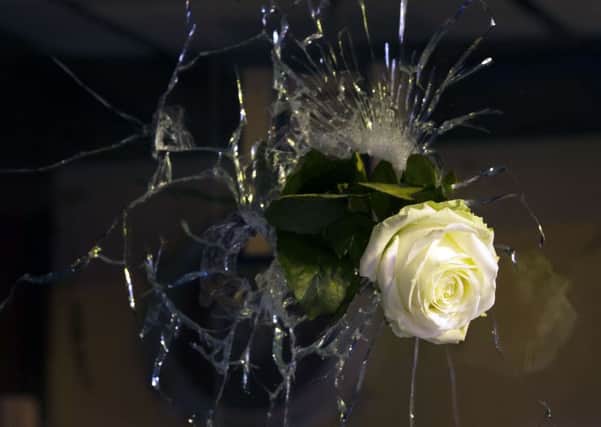 A rose is pictured in a bullet hole in a window, rue de Charonne, in Paris. Picture: AFP/Getty Images