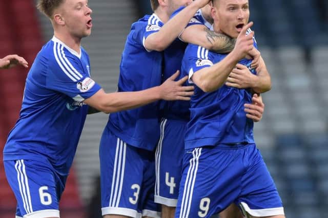 Rory McAllister, right, celebrates opening the scoring. Picture: SNS Group