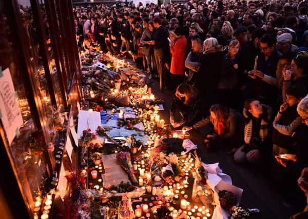 People light candles at a makeshift memorial in front of "Le Carillon" restaurant one of the site of the attacks. Picture: AFP/Getty Images