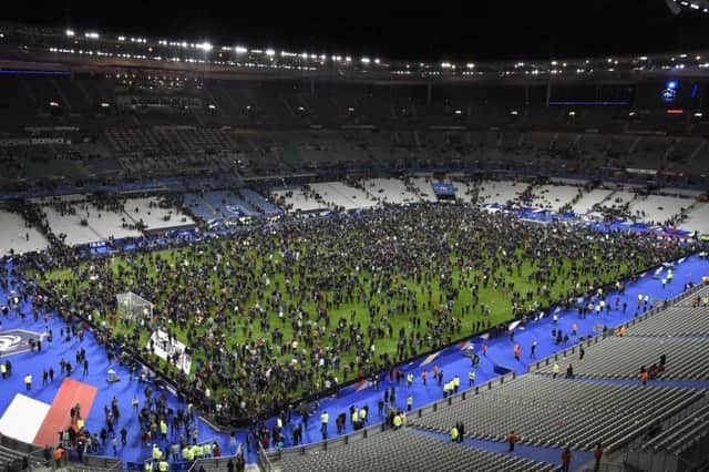 Spectators gather on the pitch following the match. Picture: AFP/Getty