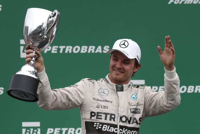 Mercedes driver Nico Rosberg of Germany greets fans after finishing first at the Interlagos track ahead of team-mate Lewis Hamilton. Picture: AP