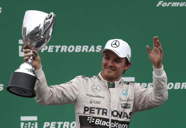 Mercedes driver Nico Rosberg of Germany greets fans after finishing first at the Interlagos track ahead of team-mate Lewis Hamilton. Picture: AP