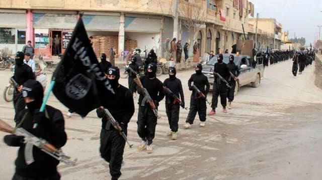 IS fighters march in in Raqqa, Syria. Picture: AP