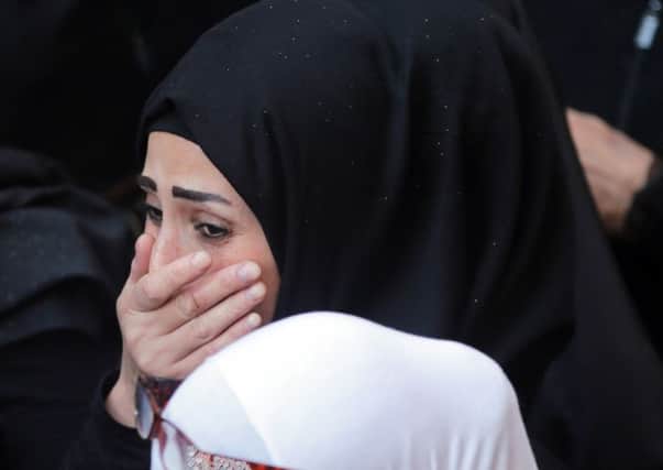 Family members mourn a relative who was killed in a bomb attack that rocked a busy shopping street in the Lebanese capital Beirut last week. Picture: Getty
