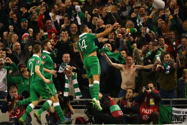 Jonathan Walters leaps into the air with joy after opening the scoring from the penalty spot in Dublin last night. Picture: Getty