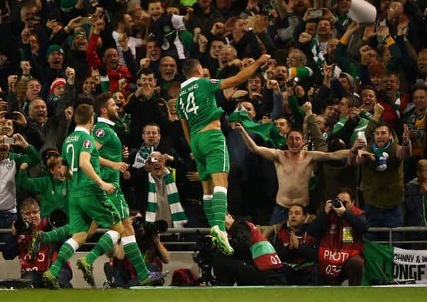 Jonathan Walters leaps into the air with joy after opening the scoring from the penalty spot in Dublin last night. Picture: Getty