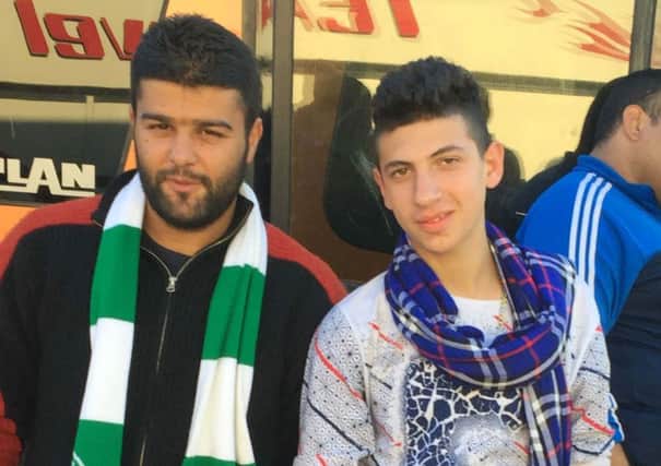 24-year-old Abdel Baset (left) wearing a Celtic FC scarf he hopes will keep him warm as winter approaches. Picture: PA