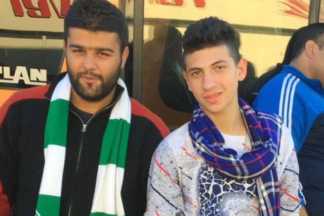 24-year-old Abdel Baset (left) wearing a Celtic FC scarf he hopes will keep him warm as winter approaches. Picture: PA