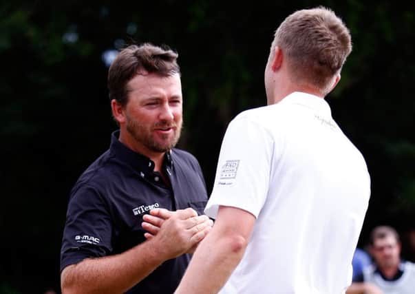 Russell Knox, right, shakes hands with Graeme McDowell after his play-off loss to the Ulsterman. Picture: Getty