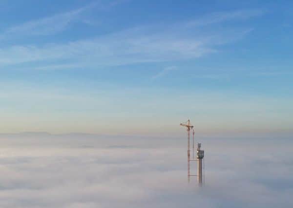 The tip of the Queensferry Crossing is just visible above the fog. Picture: John Muirhead