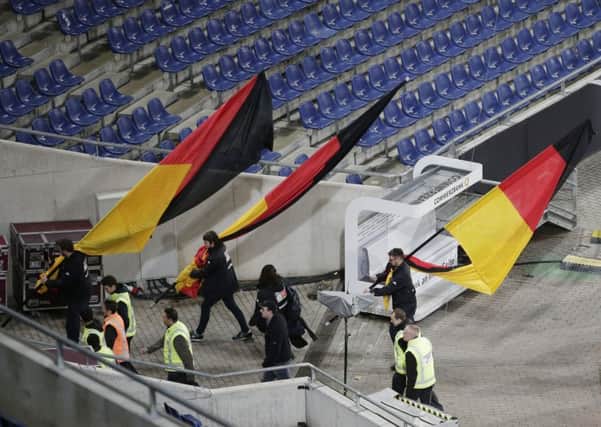 German flags are carried out of the stadium after the friendly between Germany and the Netherlands was cancelled in Hannover. Picture: Michael Sohn/AP