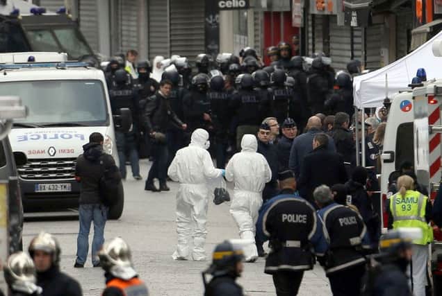 Police activity during a raid on an apartment in the Saint Denis suburb of Paris yesterday. Picture: PA