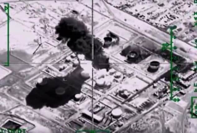 A still from a video on the Russian Defence Ministry's website purporting to show an explosion after airstrikes on an Islamic State oil-processing facility in Syria yesterday. Picture: AFP/Getty