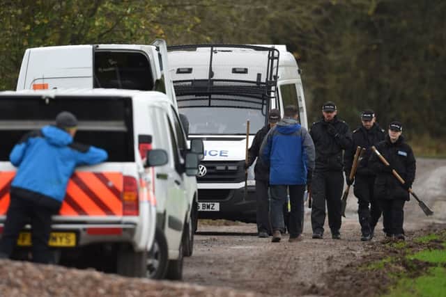 Police make their way across a field in Ibstock, Leicestershire, near to where the body was found. Picture: PA