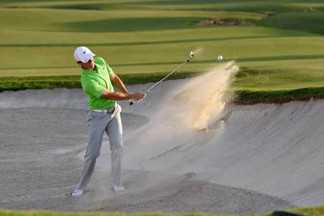 Rory McIlroy, holing out from a bunker at the 18th yesterday, would rather see Tiger Woods playing in next years Ryder Cup. Picture: Getty