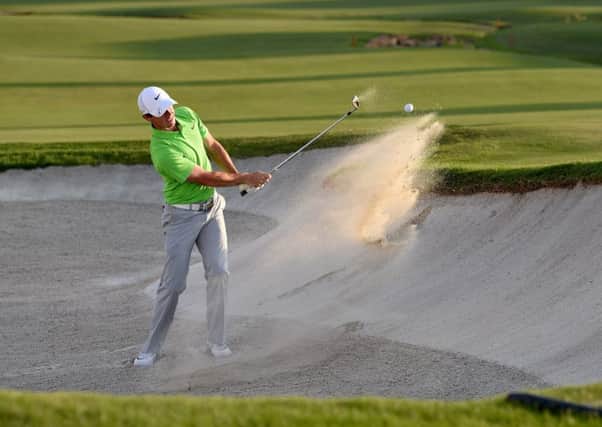 Rory McIlroy, holing out from a bunker at the 18th yesterday, would rather see Tiger Woods playing in next years Ryder Cup. Picture: Getty