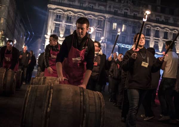 Barrels of Beaujolais Nouveau are rolled by wine-growers in Lyon during this week's launch. Picture: Getty