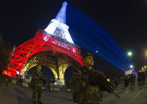 A French soldier below the Eiffel Tower, normally the backdrop for tourist snaps Picture: Getty
