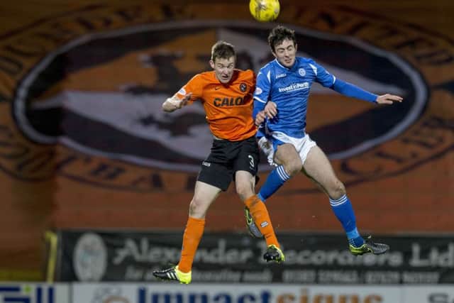 Paul Dixon (left) battles with St Johnstone's Joe Shaughnessy. Picture: SNS