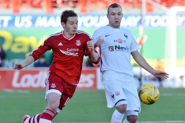 Grant Gillespie, right, wears the specially-made France shirt as he battles for possession with Peter Pawlett. Picture: SNS